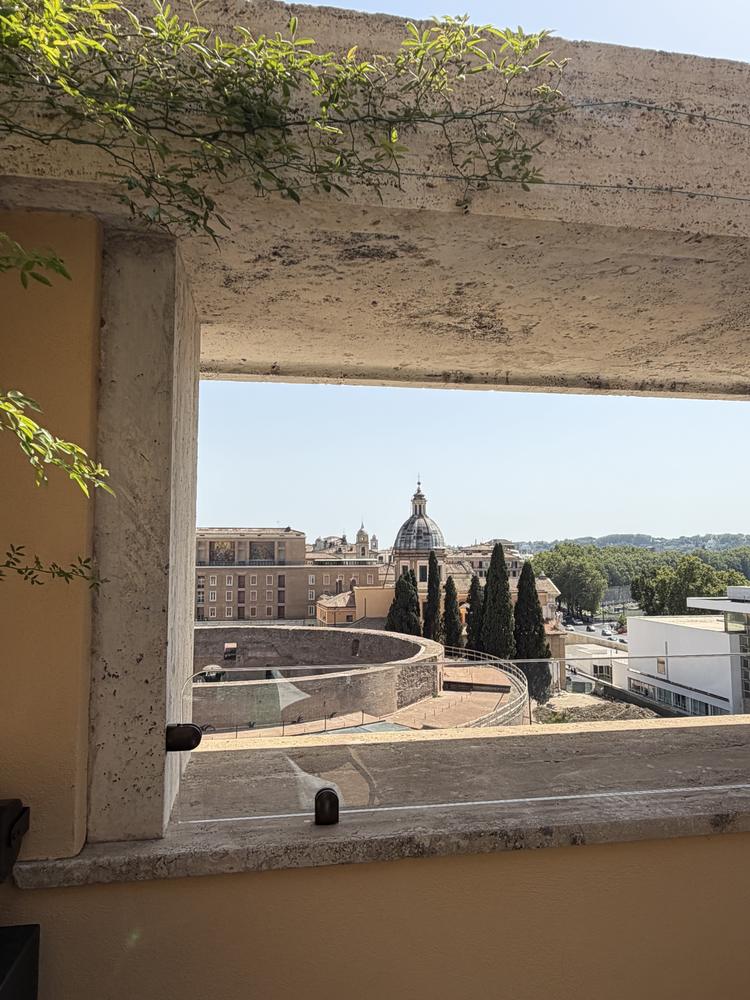 A Roman dome framed by a travertine window