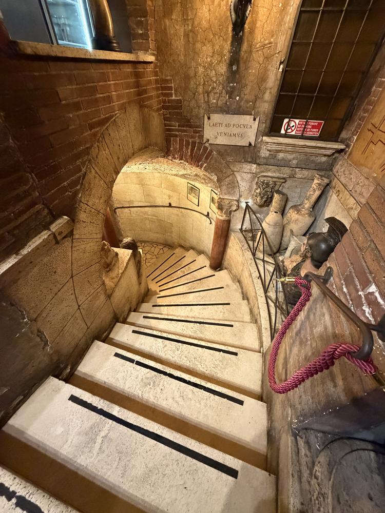 A spiral stone staircase in an old Roman wine bar
